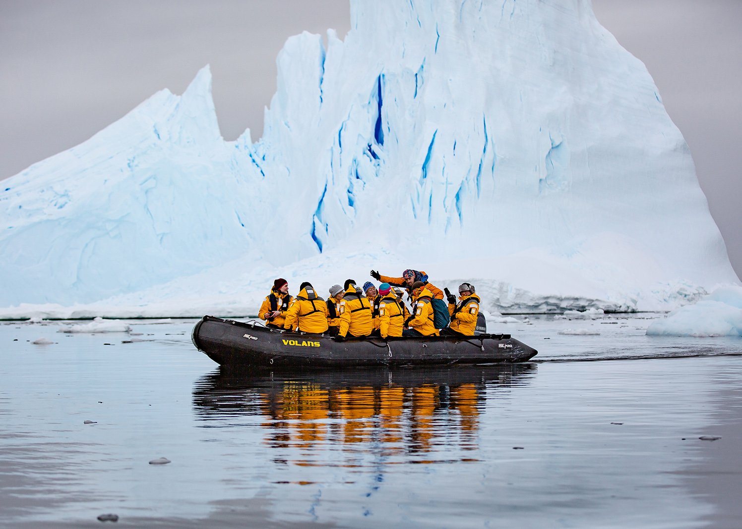 Guests of Quark Expeditions enjoy a close-up view (within a safe distance) of an iceberg while on a Zodiac cruise. Such ice formations can be seen in various parts of Iceland and Greenland.
